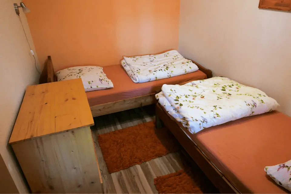 Sypialnia z dwoma łóżkami oraz szafką